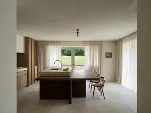 A modern kitchen with a wooden table and chairs, a tile floor, and a window in the background, well-lit and inviting
