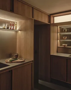 Warm and inviting kitchen with wooden cabinets, a countertop, and dim lighting