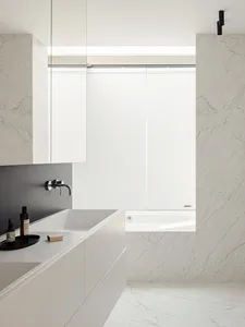 Bathroom with a sink, bathtub, and window, featuring a marble countertop and modern style