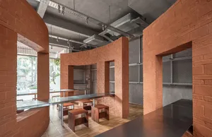 A warm and inviting restaurant dining area with a brick wall, wooden chairs, and a dining table, set in a soft and diffused lighting environment