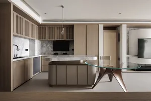 Warm and inviting kitchen dining area with a wooden island, glass table, and dim lighting