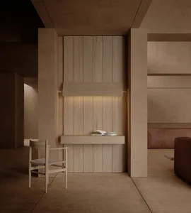 A well-lit living room with a wooden floor, a couch, a chair, and a wooden desk, creating a comfortable and inviting atmosphere