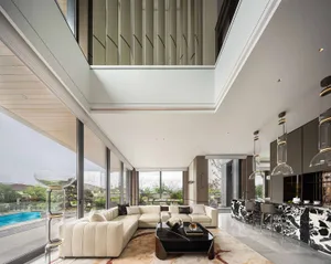 Open living space with cathedral ceiling, natural light, and modern furniture, including a couch, chair, and dining table, set against white walls and wood flooring