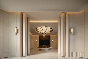 Large, well-lit room with a high ceiling, circular light fixture, and soft warm lighting, predominantly white with decorative elements