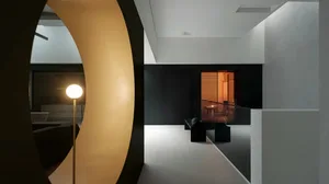 Black and white dining room with a glass door, a table, and a chair, featuring a modern style with clean lines and minimal decoration