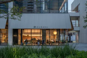 Well-lit restaurant interior with modern furniture, large glass front, and natural light