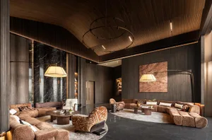 A modern living room with comfortable seating, potted plants, and dim lighting, featuring a contemporary design with clean lines and minimalistic style