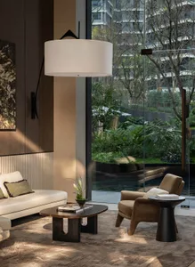 Comfortable modern living space with a large window, a couch, a chair, and a dining table, surrounded by various decorative items and natural light