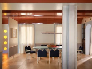 Dining room with a wooden floor, a glass table, and potted plants, well-lit and modern, with a focus on functionality and comfort