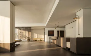 A modern living space with a white ceiling, large window, dining table, counter, couch, and chair, featuring wood and glass materials and a comfortable atmosphere