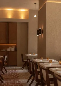 A dimly lit restaurant interior with wooden tables, chairs, and decorative items, creating a warm and inviting atmosphere for guests