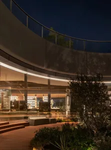 A circular lobby with benches and chairs, natural light streaming in through a large window