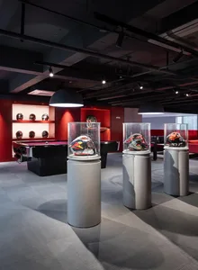 Casual game room with a red accent wall, a black pool table, and sports equipment on display