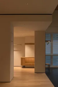 Cozy modern kitchen with a wooden counter, sink, and bench in a dimly lit space