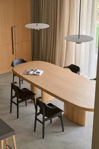 Cozy dining space with a wooden table and chairs, natural light, and a warm color scheme