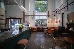 Cozy restaurant interior with wooden accents, metal details, and natural light from a window