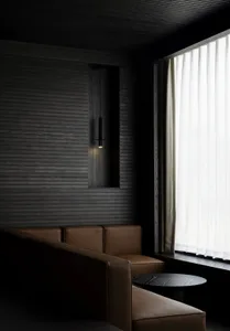 Cozy living room with a black and white color scheme, leather furniture, and a lamp near a window