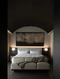 Cozy bedroom with a white bed, brown blanket, and black and white color scheme, featuring a large window for natural light
