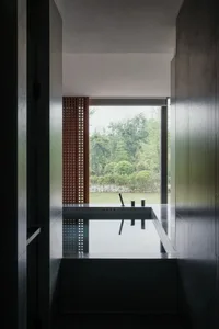 A modern bathroom with a large window, sink, bathtub, and toilet, featuring a bright and airy atmosphere