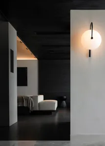 A black and white living room with a couch, chair, and bed, arranged to create a cozy atmosphere