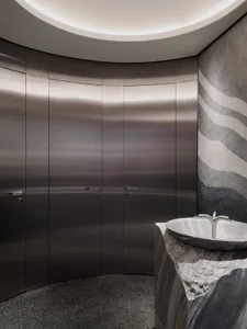 Modern bathroom with a silver sink and shower, well-lit and inviting