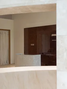 Bathroom with a marble countertop, sink, and mirror in a well-lit space