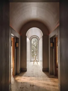 A modern hallway with a wooden floor and a wooden table, illuminated by natural light, creating a warm and inviting atmosphere