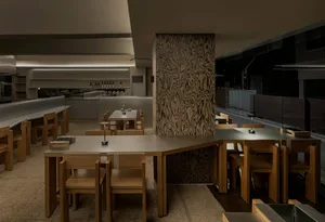 Dimly lit dining area with wooden tables and chairs, creating a cozy atmosphere