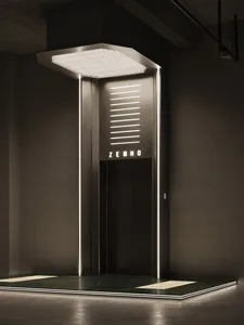 商業大樓走廊中一張光線昏暗的照片，展示一款流線型金屬電梯