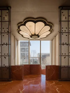 Well-lit lobby with marble flooring, a large window, and warm atmosphere