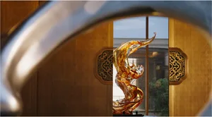 A modern room with a large glass metal and wood sculpture, elegant and sophisticated design, natural and artificial lighting