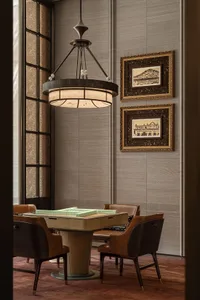 Cozy modern living space with a wooden floor, leather furniture, and dim lighting