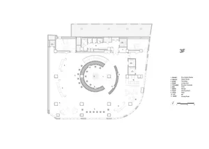 2D top-down floor plan of a modern building with a circular center, surrounded by other rooms, featuring concrete and glass materials, with natural lighting and an open and spacious atmosphere