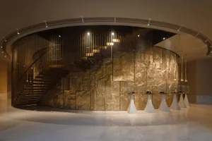 A bright and inviting lobby with a marble staircase, clean lines, and minimalistic design elements