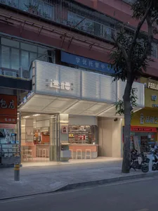 A modern restaurant with a large window, wood, and metal elements, furnished with chairs and dining tables, creating a warm and welcoming atmosphere