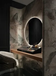 Bathroom with a black vanity, a large mirror, and a marble countertop, well-lit and inviting