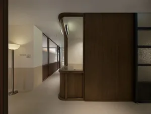 Dimly lit hallway with a wooden wall and counter, featuring a simple and functional design