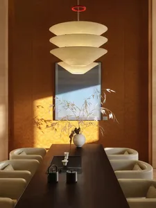 Dining room with a wooden table and chairs, set with a vase and a cup, surrounded by warm and inviting atmosphere