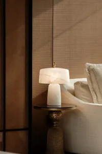 Cozy living room with a white couch and a lamp on a table, dimly lit for a relaxing atmosphere