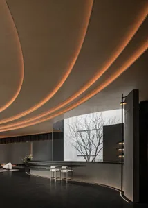 Modern lobby with a curved ceiling, large window, and comfortable seating area