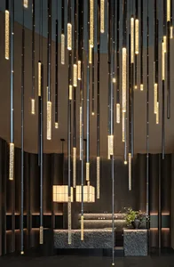 Modern lobby with a metal light fixture, well-lit space, and inviting atmosphere
