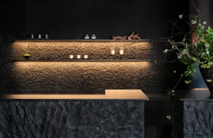 Elegant kitchen with a marble countertop, candles, a vase, and a bowl, creating a sophisticated atmosphere