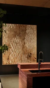 Modern bathroom with a sink and a large brown and white wall hanging, adding a unique touch to the space