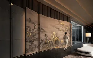A woman walks towards a large, ornate wall hanging with a dragon design in a dimly lit, modern room with a black and gold color scheme