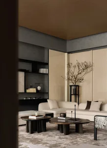 A modern living room with a couch, chair, and dining table, decorated with a vase, potted plant, and bowl, in a well-lit space with a comfortable atmosphere