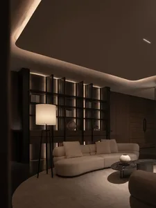 Cozy living room with white furniture, a bookshelf, and warm lighting
