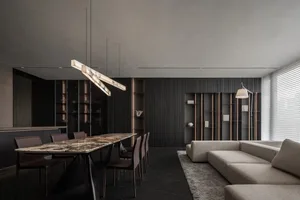 A modern living and dining space with a wooden theme, featuring a couch, chair, dining table, and chairs, with dim lighting creating a cozy ambiance