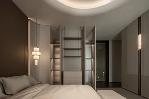 A well-lit bedroom with a white bed, a bookshelf, and a closet, creating a clean and bright atmosphere
