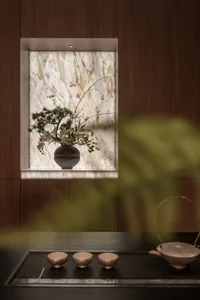 A warm and inviting living space with a wooden table, a window, and a vase of flowers adding a pop of color