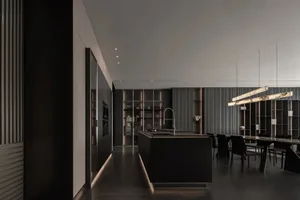 Modern kitchen and dining space with a black countertop, dining table, and natural light